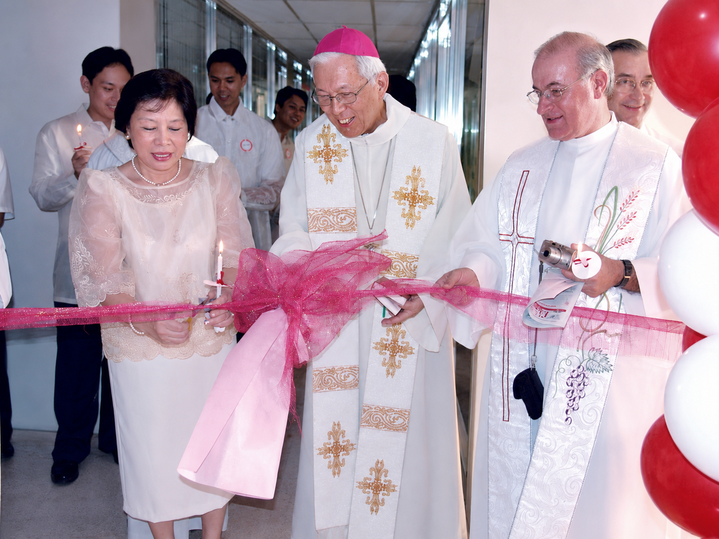 Ribbon-cutting during the blessing and opening of Sacred Heart’s new clinic