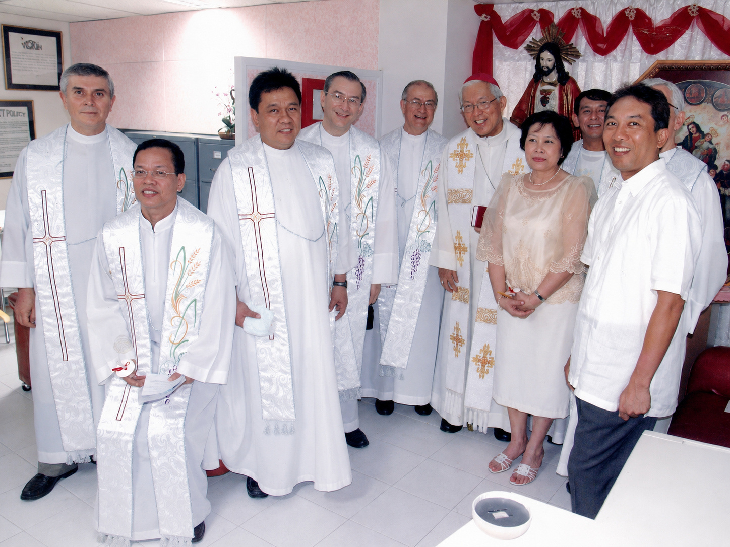 Clergy and guests join in prayerful blessing through the clinic corridor, marking the opening with faith and reverence.