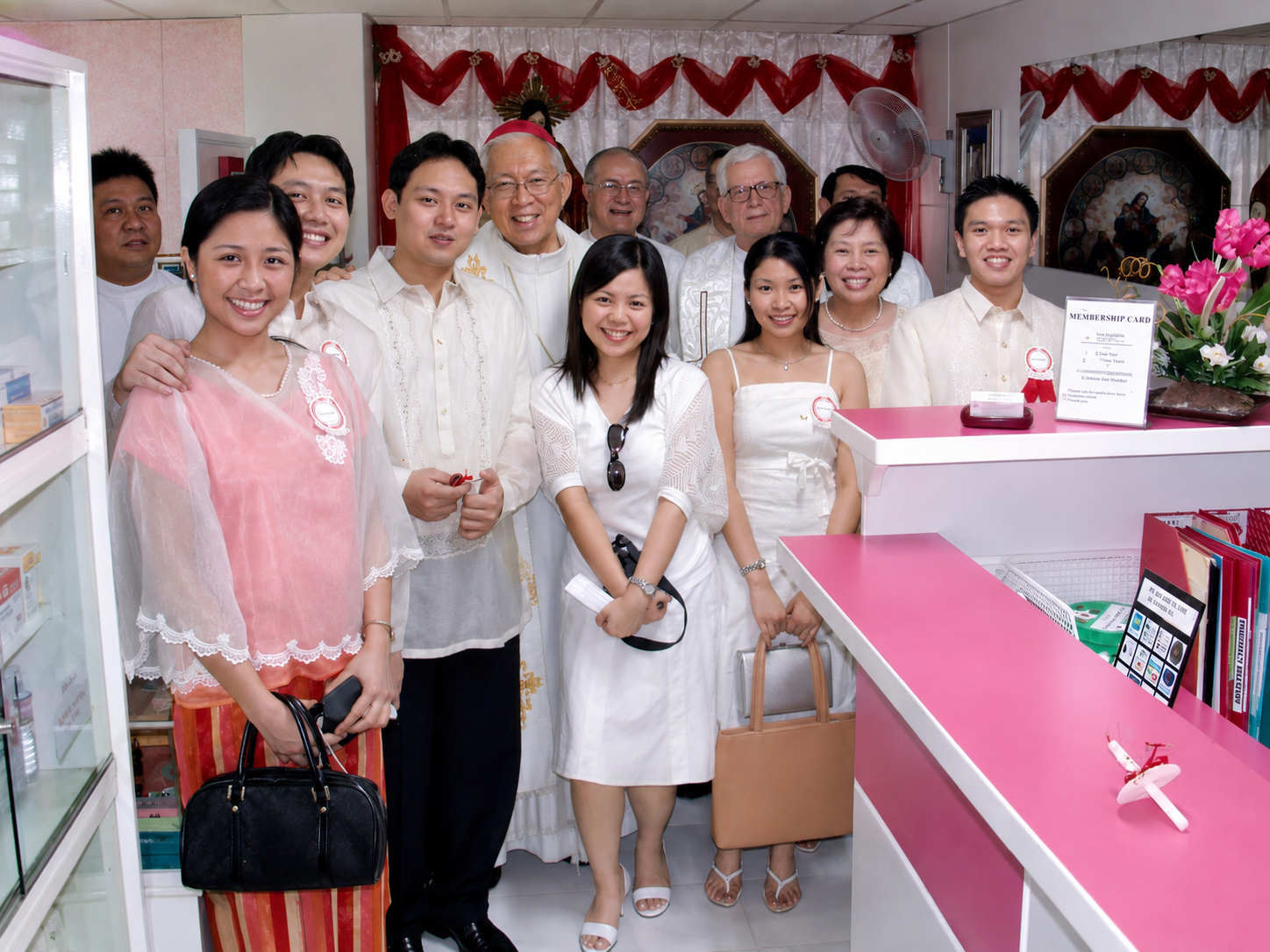Clergy, staff and guests gather after the blessing, reflecting the fellowship that marked Sacred Heart’s 25th anniversary.