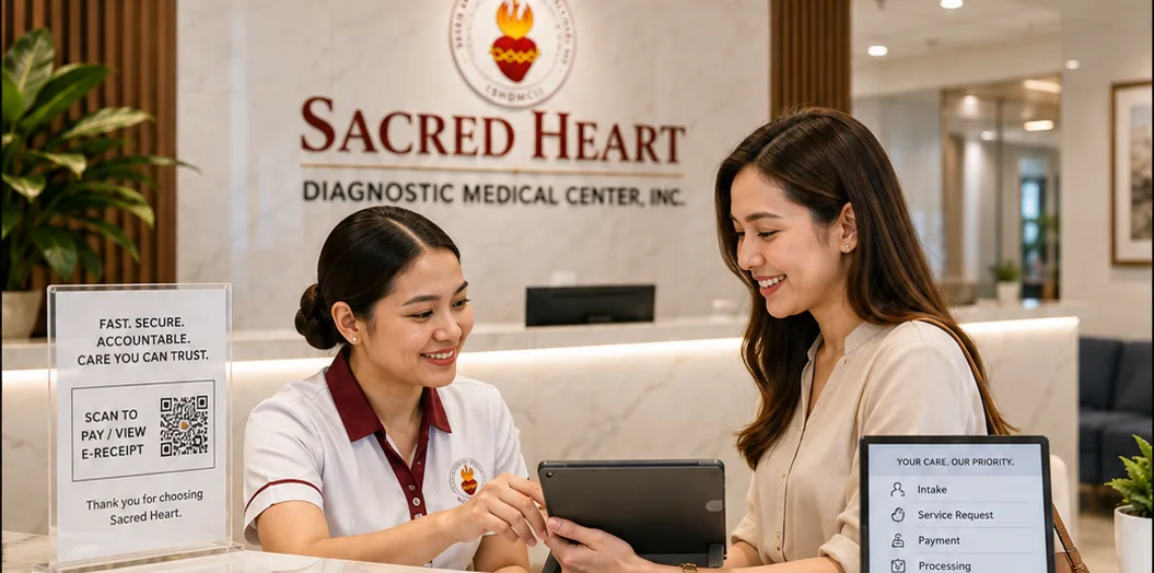 Sacred Heart front-desk staff assisting a patient with digital intake and service processing.